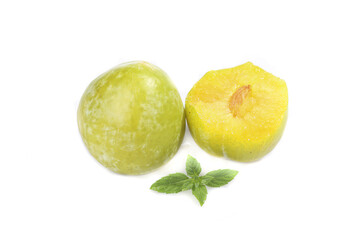 Fresh Yellow Green Plums Cut in Half with Mint Leaves Studio Photography
