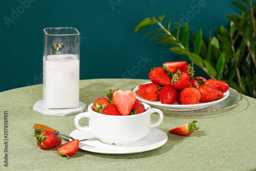 Photos Fresh Strawberries with Milk Glass and White Cup on Green Table Studio Setup