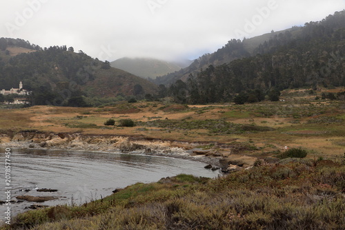 The inland mountains of Big Sur are shrouded in clouds as seen from Point Lobos, California