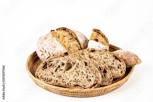 Freshly baked sourdough bread loaf on the basket and white background with full depth of field. Artisanal or healthy food concept