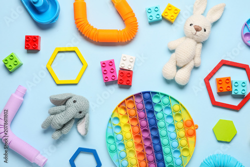 Obraz na plátně Colorful childrens toys and sensory fidget items on blue background