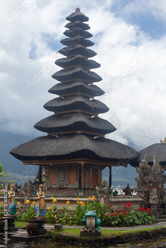Eleven-tiered meru tower against cloudy mountains at Pura Ulun Danu Beratan, Bedugul, Bali, Indonesia.