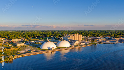 Aerial view industrial port with domes and silos at sunset along Saginaw river