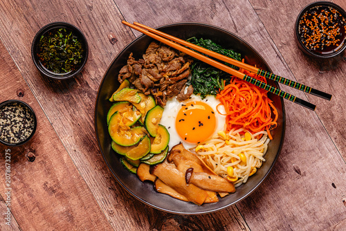 Bibimbap with colorful vegetables, beef, and egg