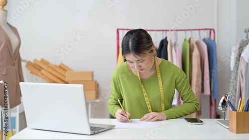 Fashion designer drawing sketches in her studio
