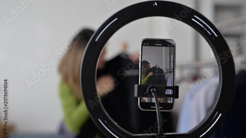 Fashion influencer creating content for social media with ring light