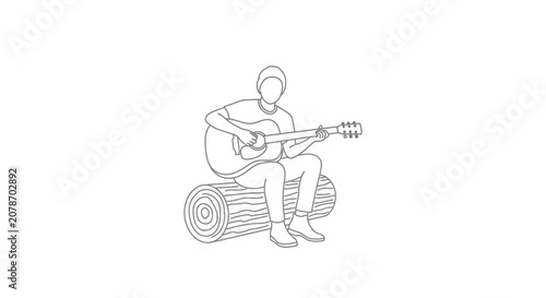 Man playing acoustic guitar while sitting on a log.