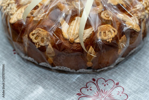 Traditional Round Loaf of Bread with Crown Decoration Wrapped in Foil.