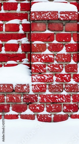 Red Brick Wall with Snow Cover in Winter Season.