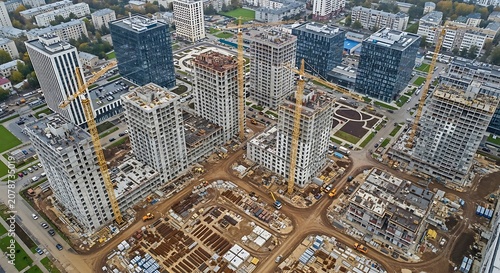 Aerial View of Modern Urban Cityscape with Tall Buildings and Construction Sites.