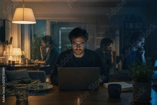 Evening focus at home a diligent man deeply immersed in his digital work