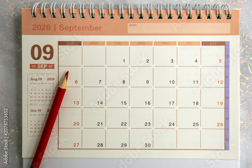 Desk calendar for September 2026 on a gray background.