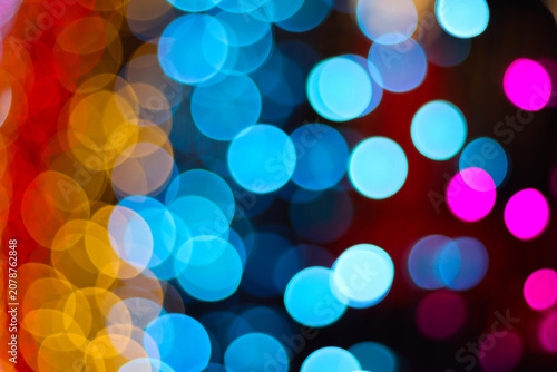 Beautiful colorful bokeh lights in dark background perfect for festive celebration banner or abstract wallpaper