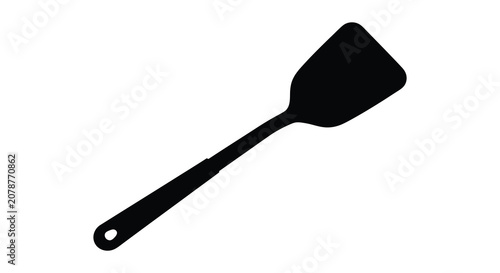 Tableau sur toile Black spatula shape against a white background a kitchen utensil silhouette