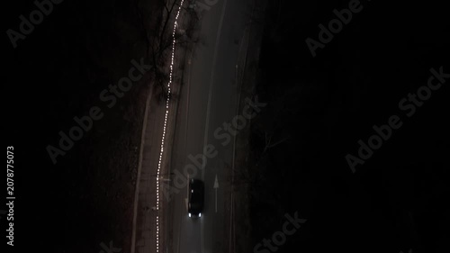 Lights along the road at night. A view of a winding road at night with lights marking the path. The scene captures the dark surroundings and the bright lights guiding drivers.