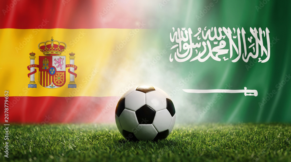 Naklejka premium Spain vs. Saudi Arabia Football Matchup: A classic soccer ball rests on a grassy field, flanked by the national flags of Spain and Saudi Arabia.