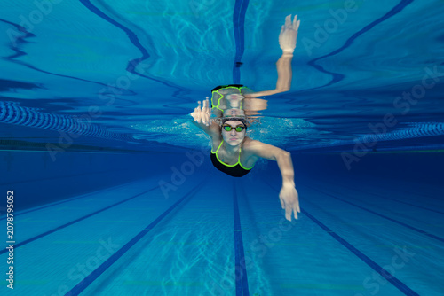 Underwater Photo of Young Female Athlete Swimming in Pool.