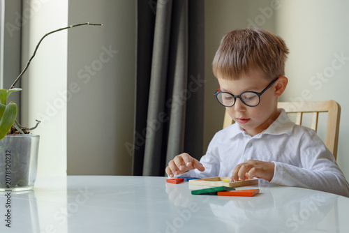 logic board games, Boy playing with educational wooden toys, a logic game developing puzzle