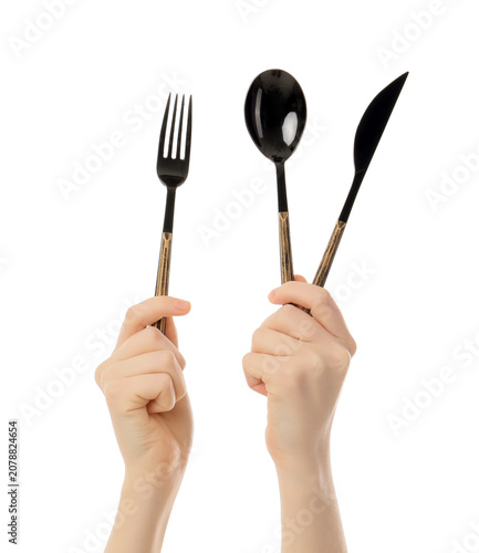 Hands holding black cutlery...