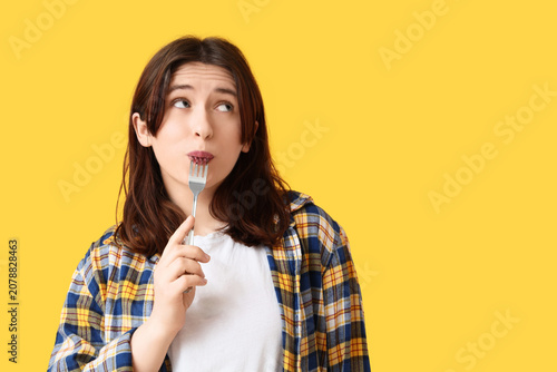 Thoughtful woman with fork ...