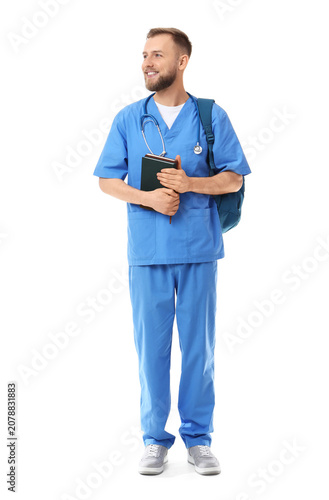 Handsome medical intern with backpack and notebooks on white background