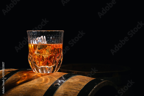 Glass of cold whiskey on wo...