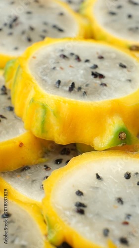 Exotic tropical fruit background with round dragon fruit pitaya slices