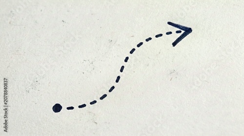 Black Dotted Arrow on White Background for Instructional Materials and Directional Guides