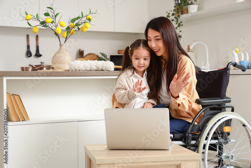 Young Asian mother in wheel...