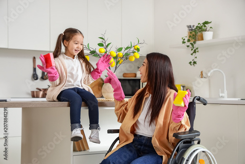 Young Asian mother in wheel...