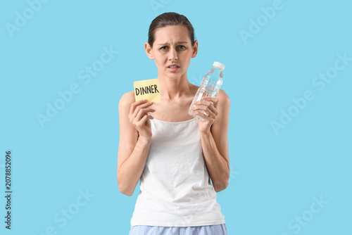 Young woman holding paper w...