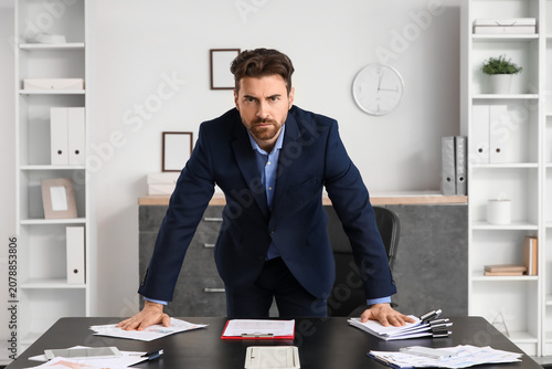 Angry businessman at table ...