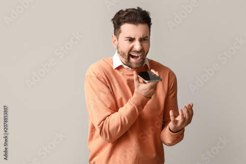 Angry male office worker sh...