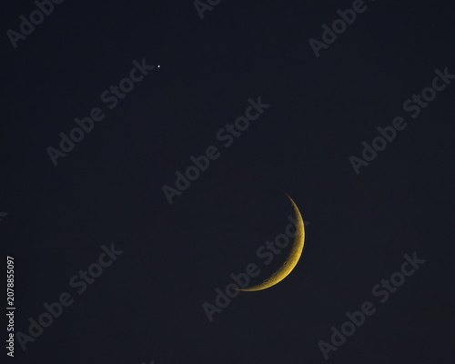 Moon in its initial phase and Venus side by side in night sky