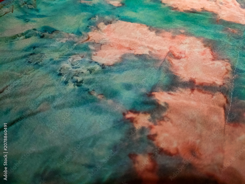 Naklejka premium sheer organdy fabric with an abstract pattern in turquoise and reddish-orange