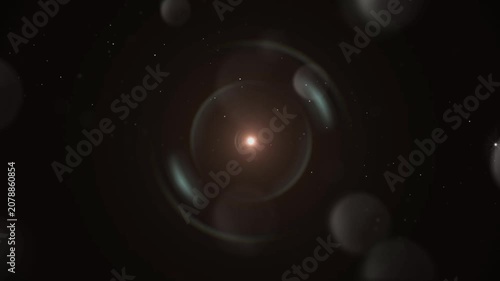 Central light orb emits a warm glowing aura surrounded by soft dark bokeh circles.