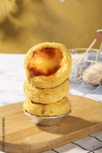 Portuguese Egg Tarts Pastéis de Nata Golden Custard Pastry Stack on Wooden Board