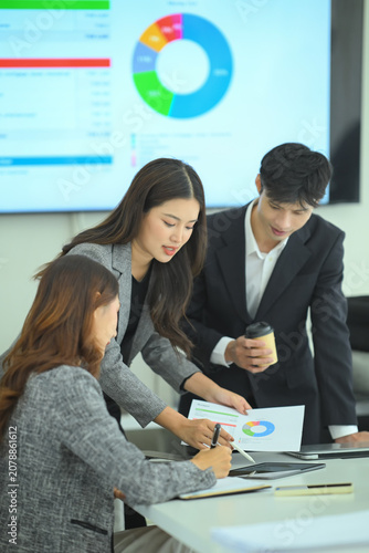 Business team reviewing strategy on laptop during meeting