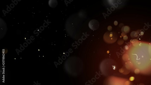 Bokeh light particles shimmer against a deep black background creating an elegant atmosphere.