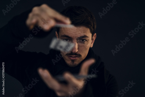 Portrait of magician conjuring with playing cards