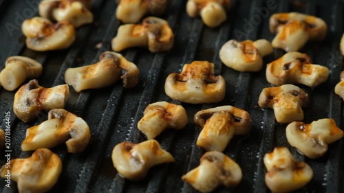 Roasted Champignon Mushroom Halves Close-up on Electric Grill.