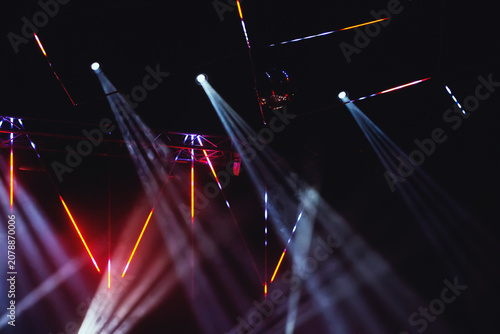 Tableau sur toile Colorful light beams create a vibrant atmosphere at a nighttime music event in a