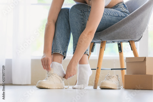 Young woman trying on new s...