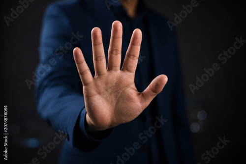 Businessman hand showing palm gestures stop, concept violence, warning, refuse, defense, caution. The hand sign of men a stop. 
