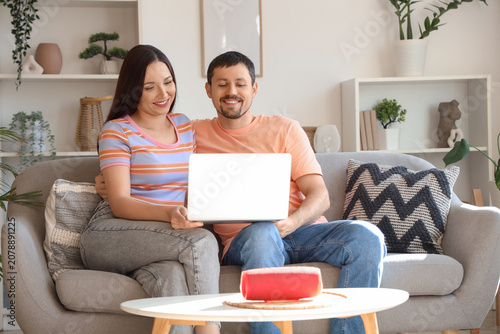 Young couple using laptop w...