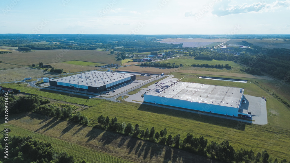 Obraz premium Two industrial warehouses in countryside
