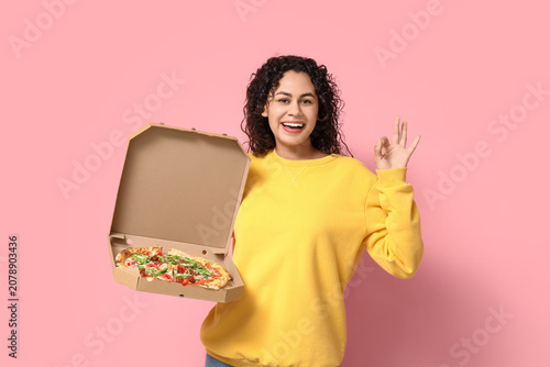 Beautiful young happy African-American woman with delicious pizza showing OK ...
