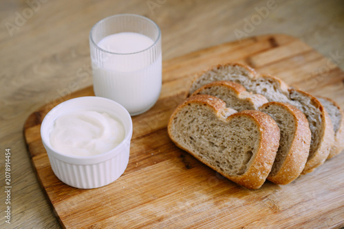 Freshly baked sourdough bread loaf with a crispy crust, partially sliced for eating