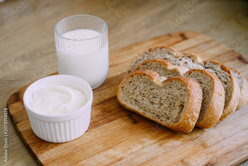 Freshly baked sourdough bread loaf with a crispy crust, partially sliced for eating