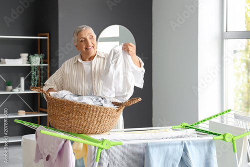 Senior woman with laundry b...